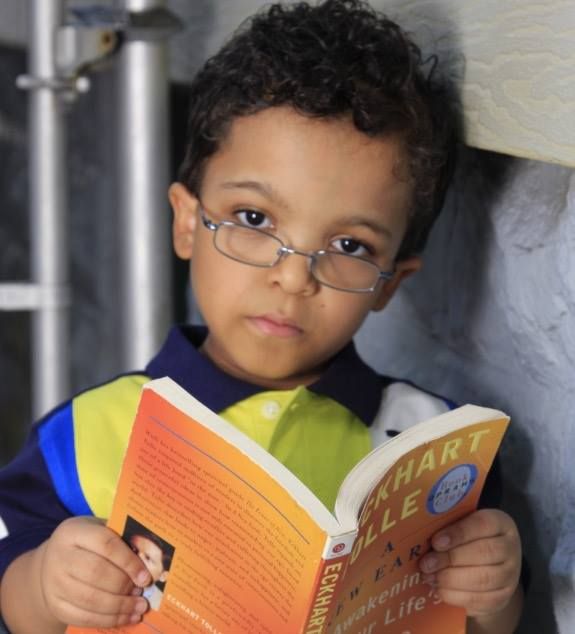 A young boy is reading a book