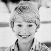 A young boy smiling for the camera.