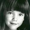 A young girl with long hair and bangs.