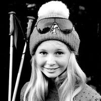 A young girl wearing sunglasses and a hat.